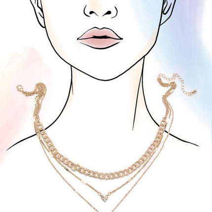 Gold layered necklace featuring multiple chains with rhinestone heart charms styled on a soft pink background.