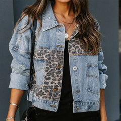 Model wearing a distressed blue denim jacket with leopard print patchwork panels, styled casually over a black top with layered necklaces.