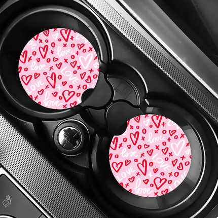 Two Valentine’s Day–themed neoprene car coasters with heart and love patterns, shown inside gift-ready packaging and styled on a neutral background.