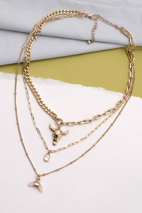 Gold plated three layer western style necklace featuring polished bull horn charm with elongated link chains and adjustable lobster claw clasp displayed on a feminine styled background.