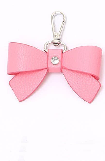 Pink bow keychain with a silver clasp on a white background