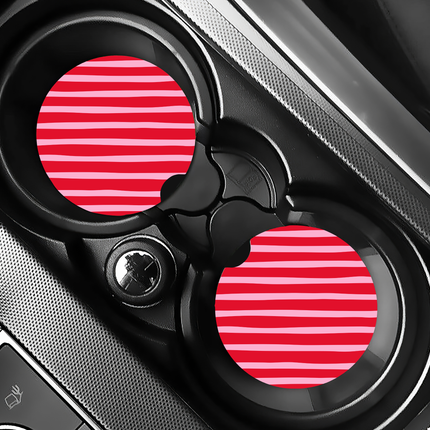 Two Valentine’s Day–themed neoprene car coasters with heart and love patterns, shown inside gift-ready packaging and styled on a neutral background.