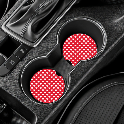 Two Valentine’s Day–themed neoprene car coasters with heart and love patterns, shown inside gift-ready packaging and styled on a neutral background.