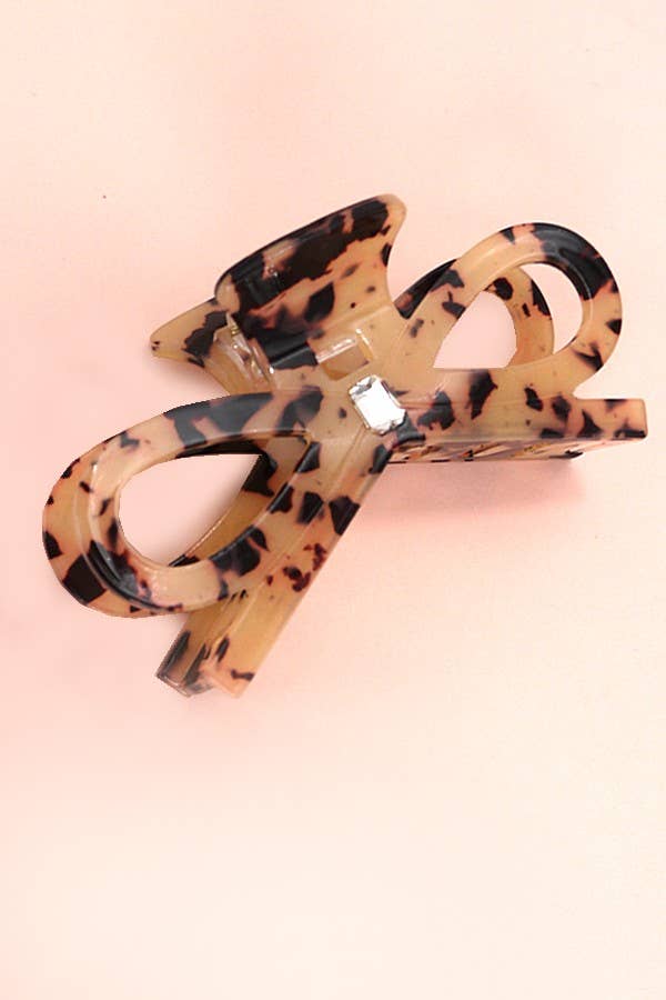 Oversized tortoise bow-shaped resin hair claw clip with rhinestone center accent, 4-inch size.