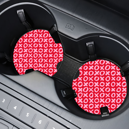 Two Valentine’s Day–themed neoprene car coasters with heart and love patterns, shown inside gift-ready packaging and styled on a neutral background.