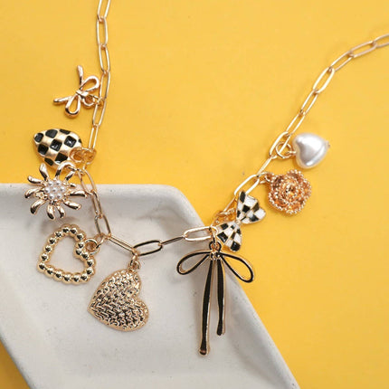 Necklace with various charms on a yellow background