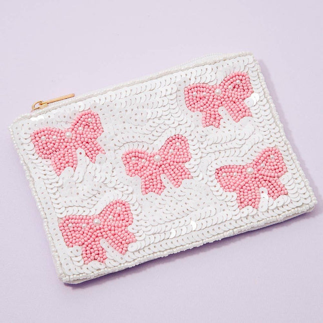 White pouch with pink butterfly designs on a light purple background