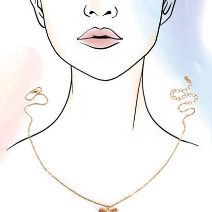 Gold necklace with a bow pendant on a minimalistic face illustration.