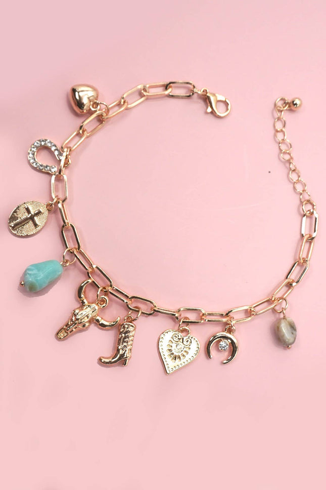 Gold western-themed charm bracelet with boot, bullhead, horseshoe, moon, heart, and stone accents on adjustable chain