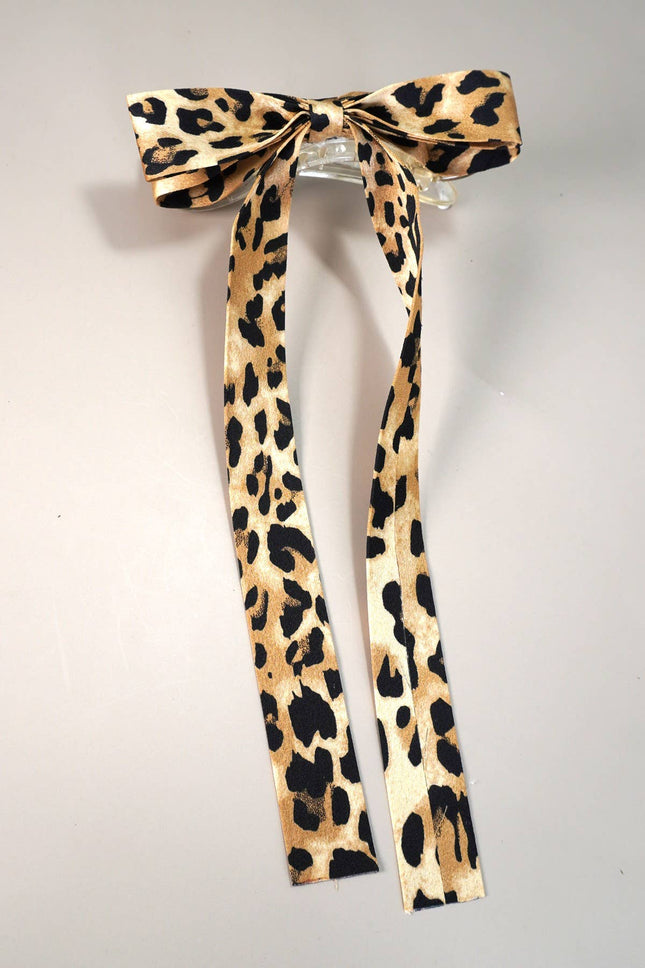 Leopard print hair bow on a gray background