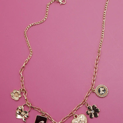 Gold charm necklace featuring bow, heart, cherry, and floral pendants on a link chain with extender clasp.