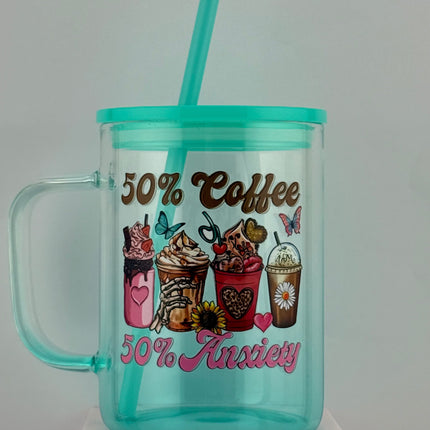 Teal tumbler with handle and straw on a white background