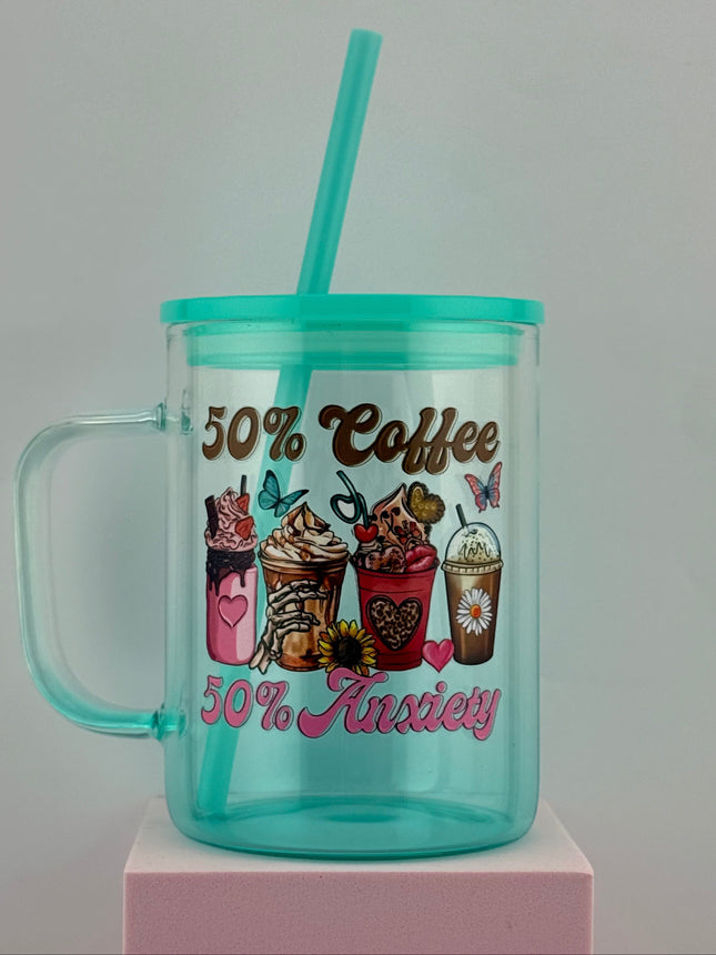 Teal tumbler with handle and straw on a white background