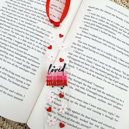 Clear acrylic Valentine’s Day bookmarks with pastel designs and soft chiffon ribbons resting inside open books, styled with a cozy, romantic bookish aesthetic.
