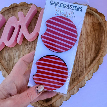 Two Valentine’s Day–themed neoprene car coasters with heart and love patterns, shown inside gift-ready packaging and styled on a neutral background.