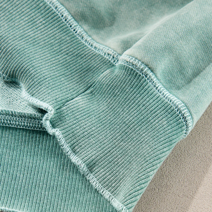 Mineral Blue waffle knit oversized sweatshirt with raglan sleeves, exposed seam down the front, and subtle lettuce-edge trim on cuffs and hem