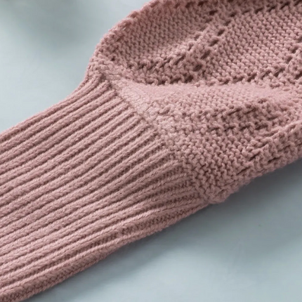 Close-up of a pink knitted garment on a light gray background