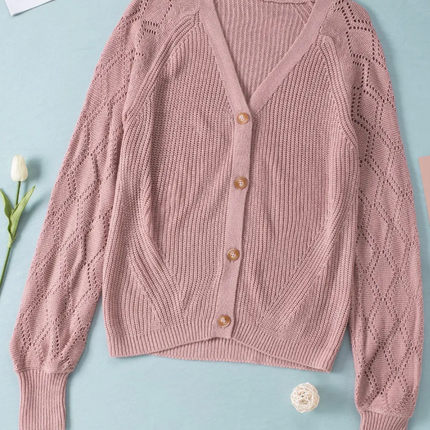 Pink knit cardigan with bishop sleeves, ribbed hem, and button-down front in soft acrylic fabric.