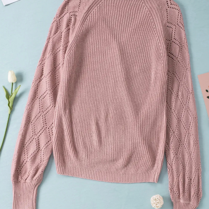 Pink knit cardigan with bishop sleeves, ribbed hem, and button-down front in soft acrylic fabric.