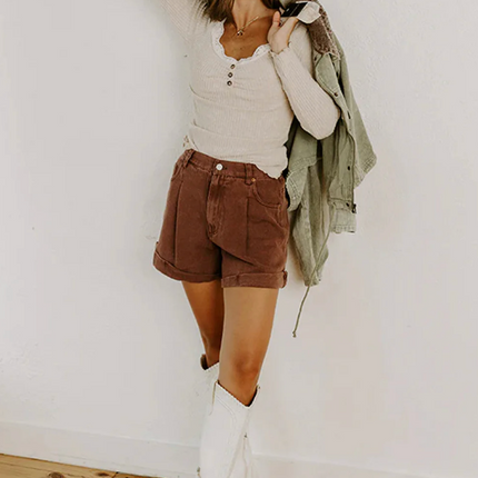 Beige ribbed knit top with lace trim neckline, button details, and lettuce-edge sleeves and hem, long sleeve fitted silhouette