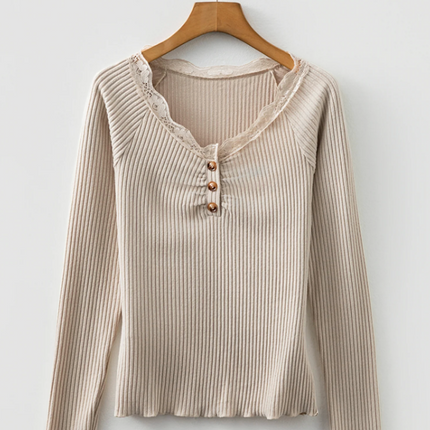Beige ribbed knit top with lace trim neckline, button details, and lettuce-edge sleeves and hem, long sleeve fitted silhouette