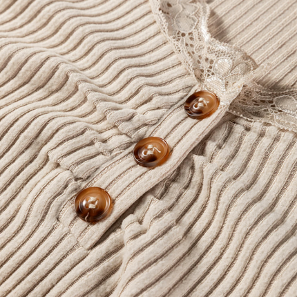 Beige ribbed knit top with lace trim neckline, button details, and lettuce-edge sleeves and hem, long sleeve fitted silhouette