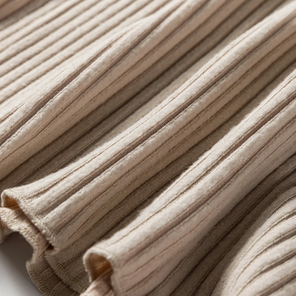 Beige ribbed knit top with lace trim neckline, button details, and lettuce-edge sleeves and hem, long sleeve fitted silhouette