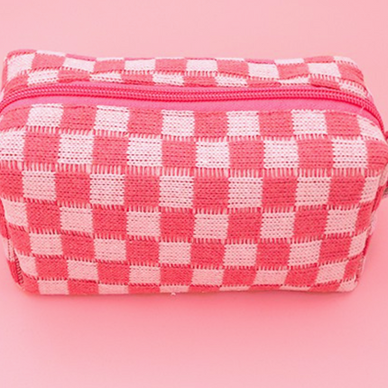 Pink and white checkered pouch on a pink background