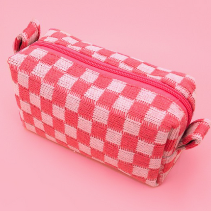 Pink and white checkered pouch on a pink background