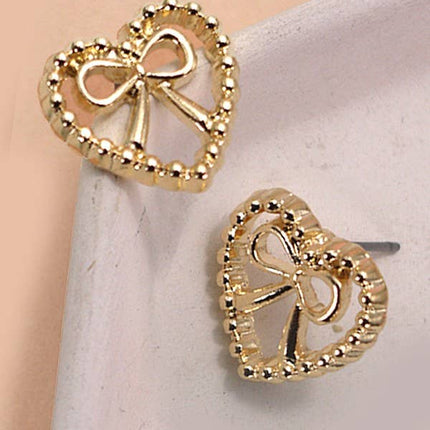 Gold-plated heart-shaped bow stud earrings with post back and anti-tarnish finish, 0.7 inches wide.