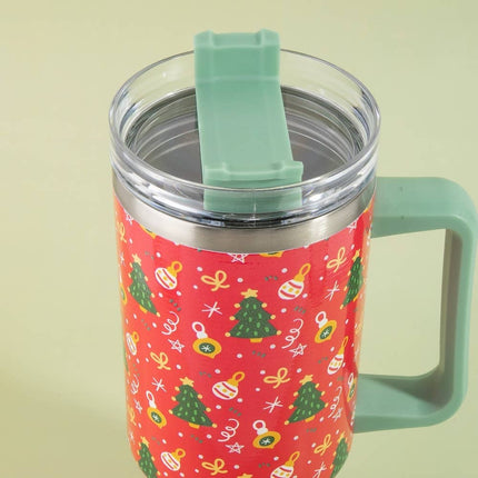 Red 40oz tumbler with green handle and lid, decorated with Christmas trees, ornaments, stars, and bows – holiday-themed stainless steel mug with clear lid.