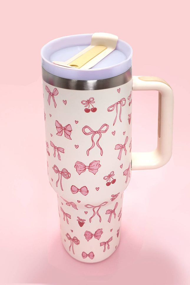 Travel mug with pink bow pattern on a pink background
