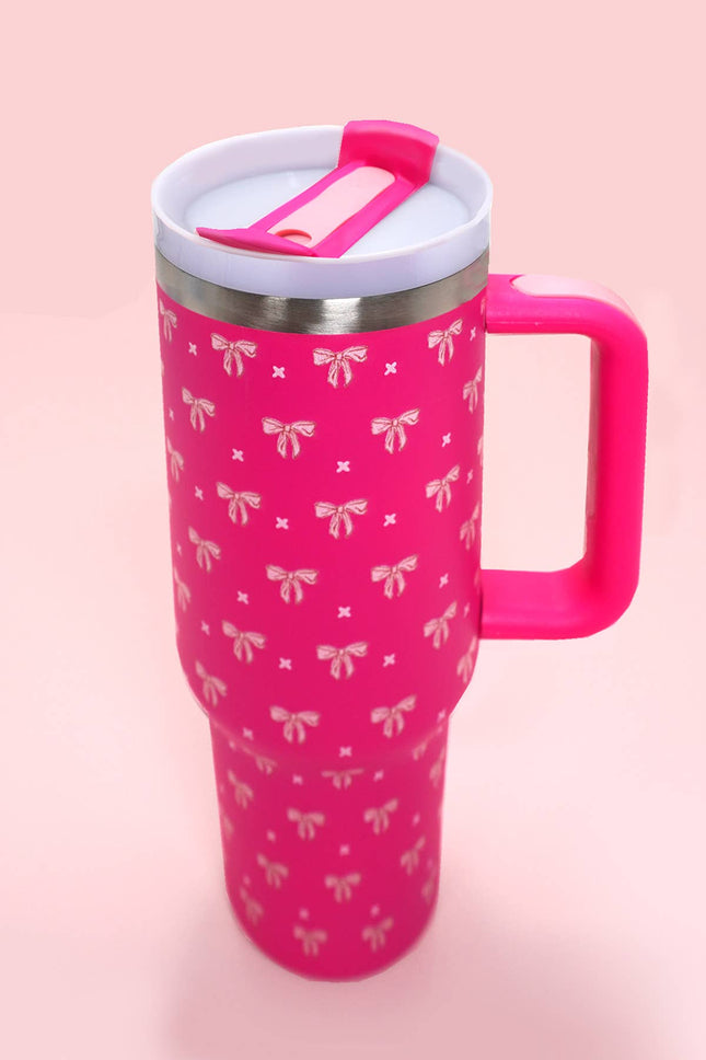 Pink mug with bow pattern and pink handle on a pink background