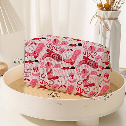 Pink cosmetic with red patterns on a white surface