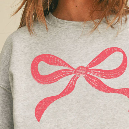 Light grey sweatshirt with pink bow graphic on chest, relaxed fit, drop shoulders, and ribbed hem and cuffs.